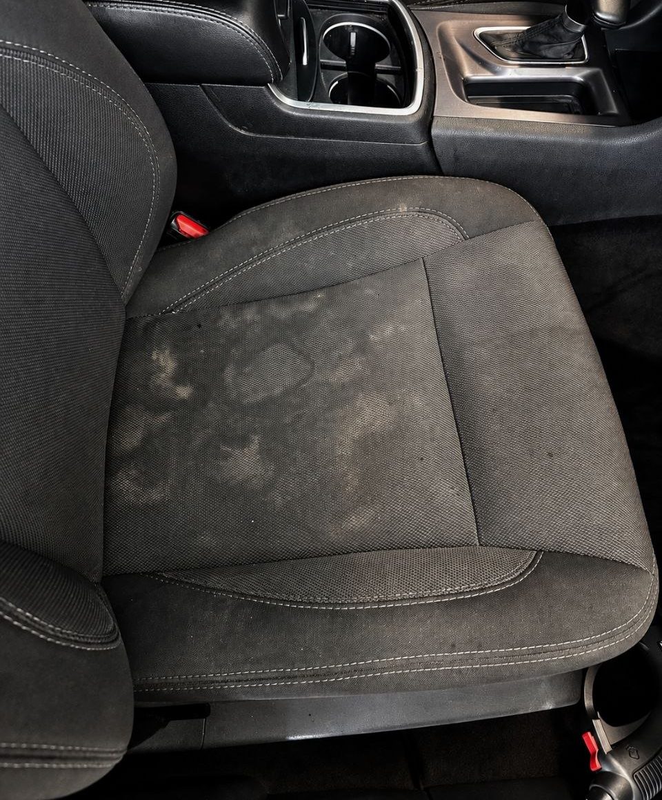 Stained cloth seat before a deep interior detail