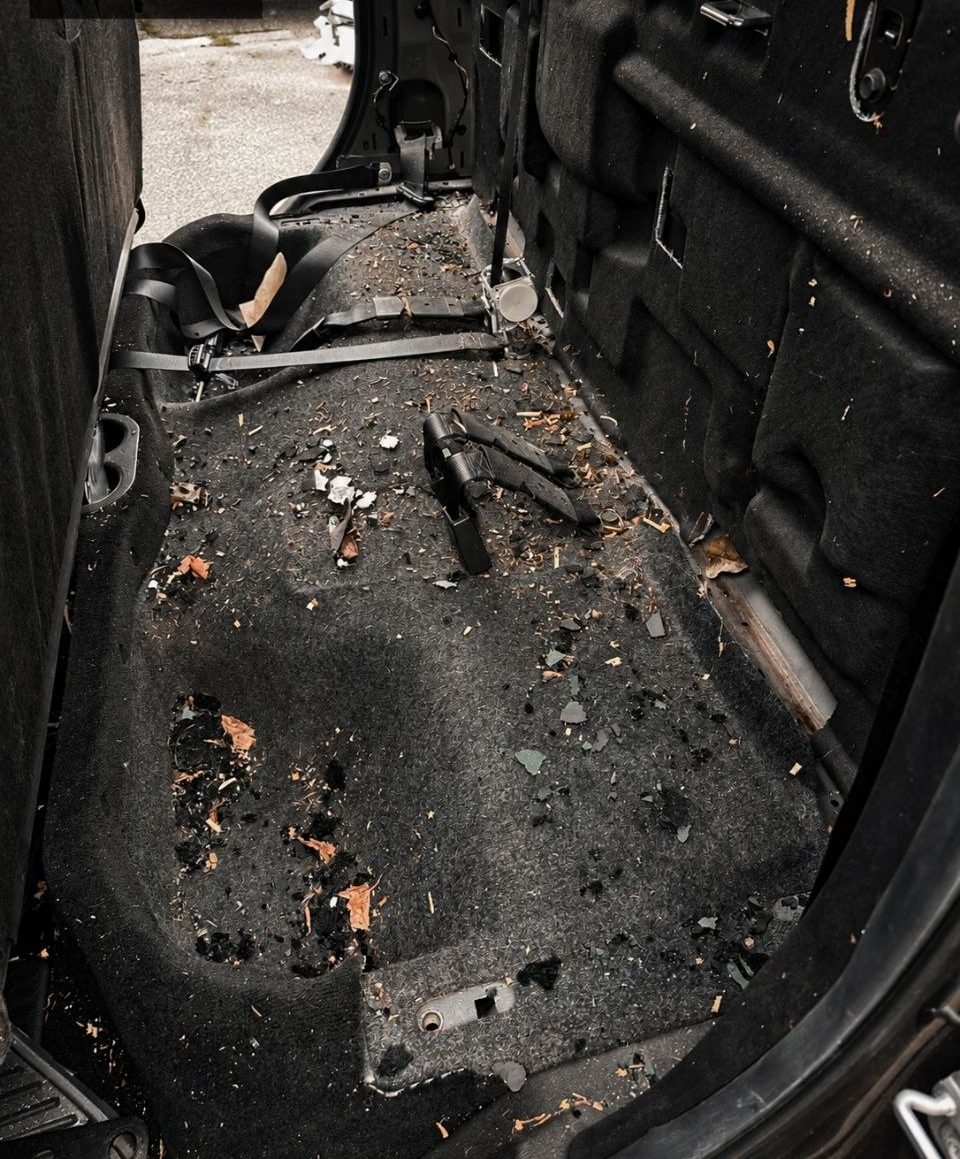 Pickup rear floor with debris before an interior detail